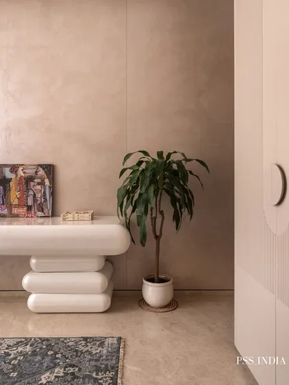 Details matter. This shot highlights the sculptural, rounded console table and the texture of the lime-washed walls, showing how even small corners can be styled with intention and character.