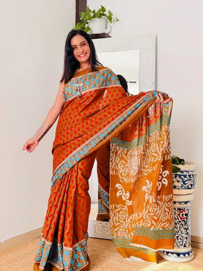 A beautiful rust-colored cotton Mulmul saree with a traditional print. The warm color is perfect for the autumn season.