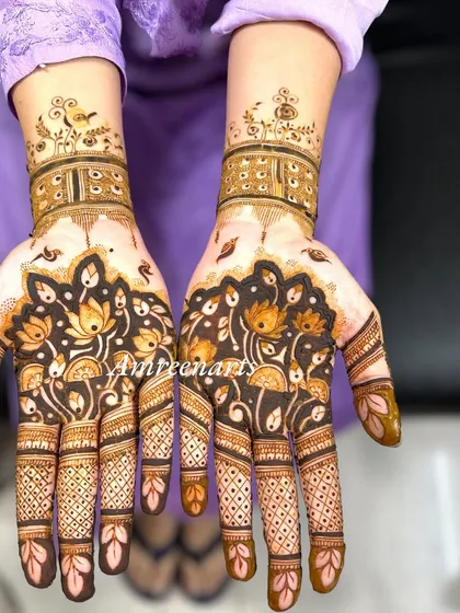 A beautiful floral design on the palms, with delicate birds on the wrist bands.