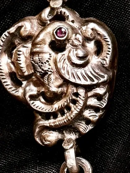 A handcrafted silver necklace featuring a 'Pride of 16 Peacocks' design, inspired by the tribal and folk patterns of rural Rajasthan. This lot also included matching peacock earrings.