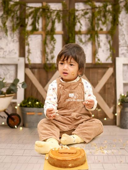 Getting right into the spirit of the cake smash. This photo captures the messy, hands-on fun that makes these sessions so memorable.