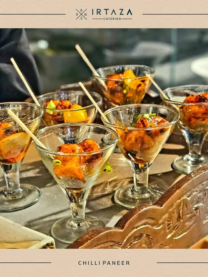 My popular Chilli Paneer, served in individual martini glasses for an elegant touch. The paneer is tossed in a flavorful sauce with peppers and onions, making it a hit at any event.