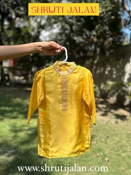 A classic sunshine yellow kurta for boys. The neckline features subtle embroidery, adding a touch of elegance to this simple, comfortable piece.