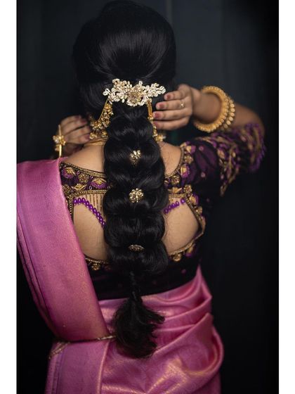 A stylish and modern take on a bridal braid, featuring a beautiful hair accessory and a neat, polished finish.