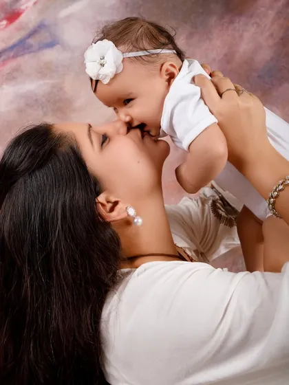 A mother's love captured in a sweet kiss. This photo with baby Ritvi is a beautiful example of the mother-daughter bond.