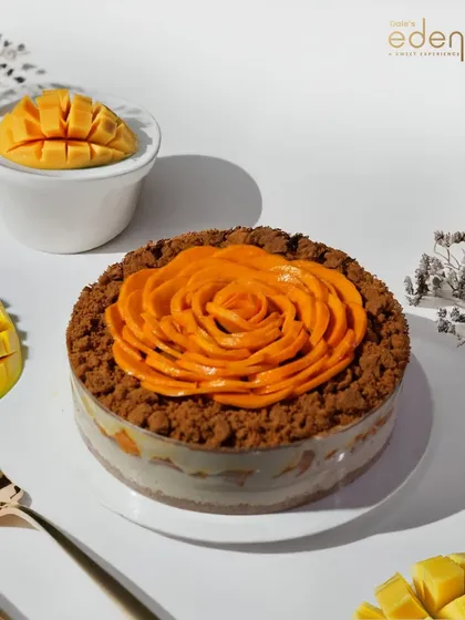 Our Mango Rose Tub Dessert, featuring layers of cream, cake, and fresh mango, topped with a beautiful mango rose and crumble.