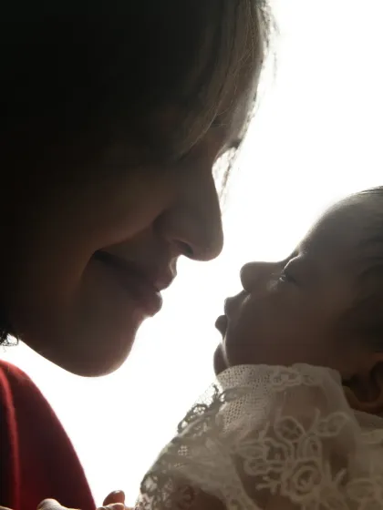 A silhouette-style shot capturing the intimate moment between a mother and her newborn, nose to nose. This artistic photo emphasizes their deep connection.