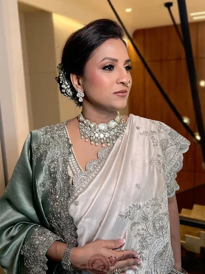A close-up of the mother, her elegant updo and soft makeup creating a look of timeless grace.