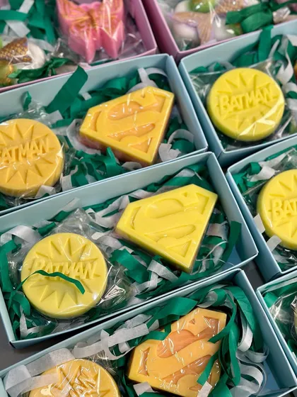 A collection of superhero soap boxes featuring Batman and Superman logos, perfect for a themed birthday.