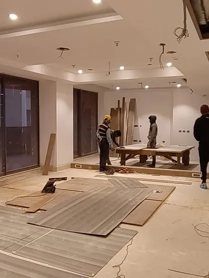 The on-site execution phase begins. This image shows a 4500 sq ft apartment at the start of the interior work, with materials laid out and the team beginning the transformation from a bare shell.