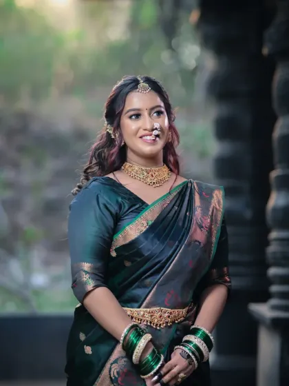 This image captures the serene beauty of the bride, with a focus on her elegant posture and the flow of her traditional attire.