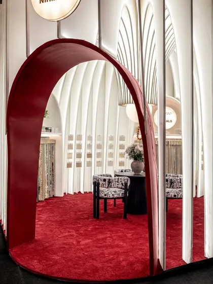 The view from the side of the entrance arch, showing how the layers of fabric create a visual rhythm. The transparency allows for a sense of openness while still defining the space.