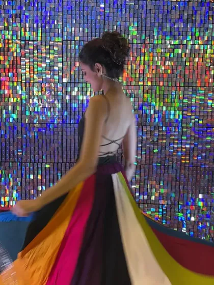 A backless choli and a twirling skirt against a shimmery backdrop. I focus on creating choreography that highlights both the dancer and their festive outfit.
