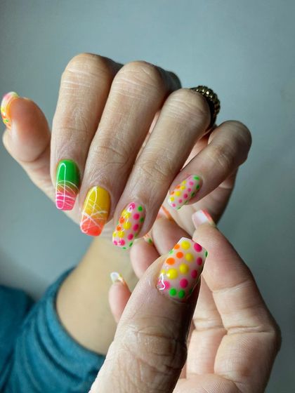 Another angle of the colorful neon polka dot and gradient nails, showcasing the fun and creative possibilities of nail art.