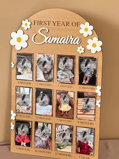 A gift that tells a story. This 'First Year of Samaira' milestone board features a photo slot for every month of her first year, decorated with cute daisies. It's a keepsake that parents will cherish forever.