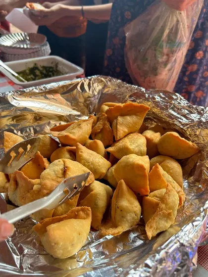 A big tray of hot cocktail samosas, ready for the hungry Holi crowd. These bite-sized snacks are easy to eat and always a crowd-pleaser.