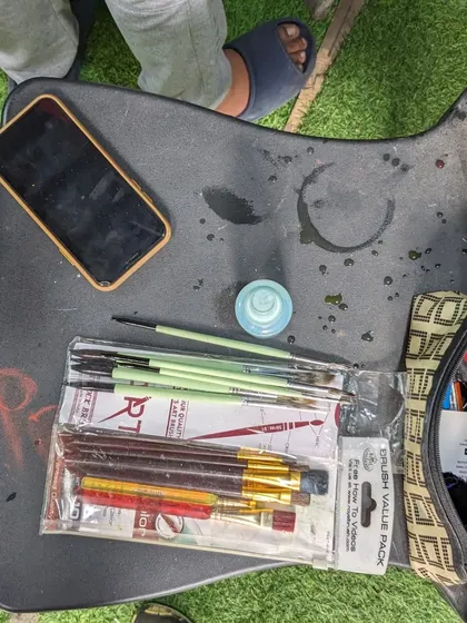 The tools of the trade. A student's desk with a new pack of brushes and a sketchbook, ready for the next creation.