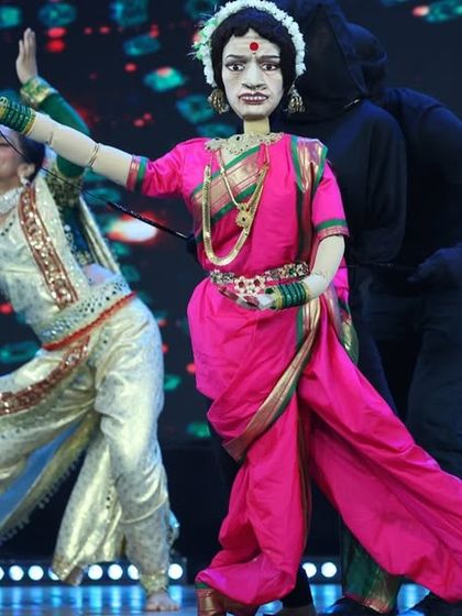 A stunning life-sized puppet of a Lavani dancer, created for our Zee Marathi special. The puppet is operated by a puppeteer in black, creating a magical illusion of dance.