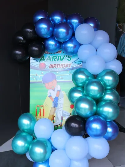 A cricket-themed welcome sign for Aariv's birthday. The blue and black balloons complement the sporty, energetic theme.