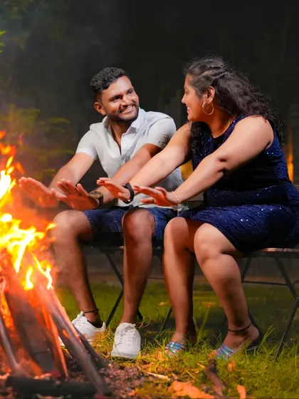A cozy and intimate moment by a bonfire. This setup is perfect for a relaxed and romantic night-time pre-wedding shoot.