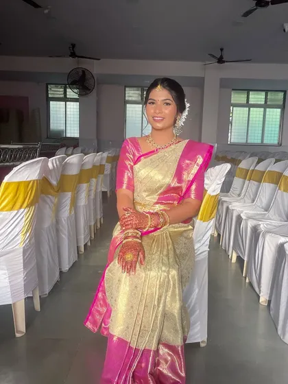 A South Indian inspired look in a beautiful cream and pink Kanjivaram saree, perfect for a wedding or traditional ceremony.
