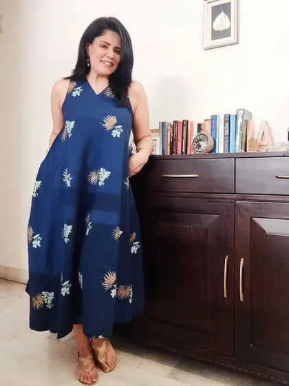 The full view of the tiered, sleeveless dress. This silhouette is flattering and comfortable, perfect for a warm summer evening.