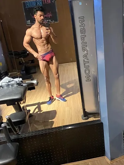 A full-body shot displaying the classic 'X-frame', with wide shoulders, a narrow waist, and developed legs. I provide detailed diet and workout plans, including intermittent fasting and macro splits, to help you achieve this aesthetic.