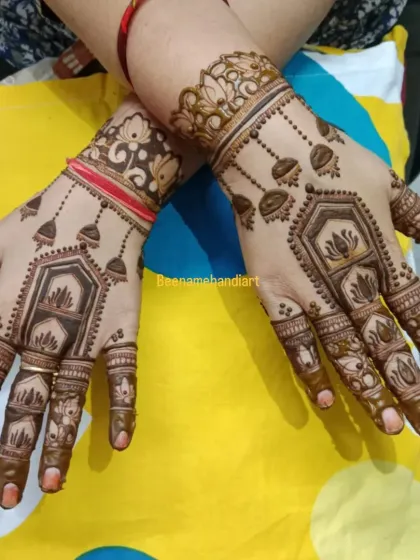 A lovely design with hanging jhumkis and lotus motifs, giving it a very festive look.