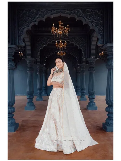 For a timeless and elegant look, consider this off-white brocade lehenga. Its subtle texture and classic silhouette make it a stunning choice for receptions, parties, or a sophisticated photoshoot.