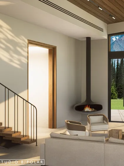 A suspended fireplace creates a cozy focal point in the corner of the living room, perfect for chilly mountain evenings. The large windows frame the stunning natural scenery outside.
