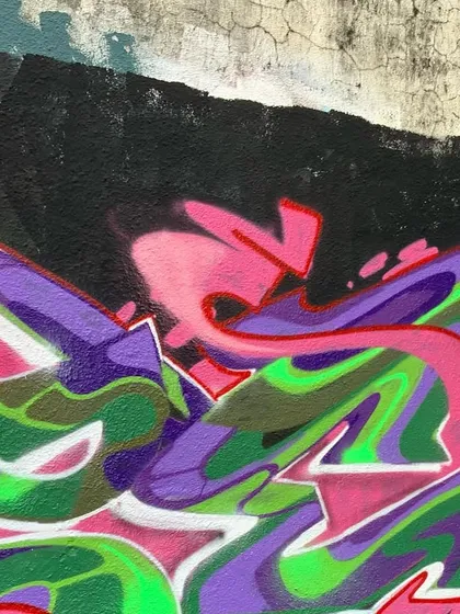 A close-up on a section of a purple, pink, and green piece. This shows my focus on flow and movement, with letters that swirl and blend into each other.