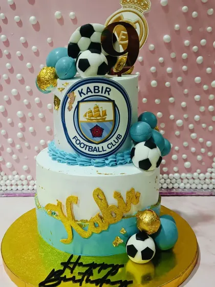 A two-tiered football club cake. This design was customized with the logo of a local football club, making it extra special for the birthday boy.