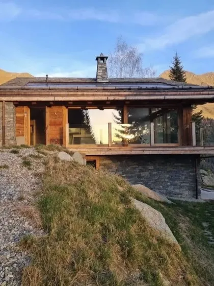 Our Swiss chalet project basking in the sun, showcasing site-specific design that respects its alpine environment. We used local stone and wood to create a home that feels both modern and deeply rooted in the landscape.