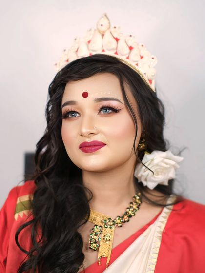A portrait capturing the divine grace of a Bengali bride, looking upwards as if towards a bright future, her traditional attire glowing.