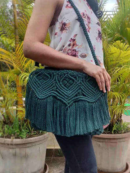 See how our classy dark green macrame sling bag completes an outfit. It's spacious enough for your essentials and adds a touch of handmade elegance to any look, from casual daywear to an evening out.