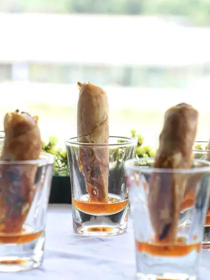 My crispy spring rolls are a perfect bite-sized appetizer. I serve them in shot glasses with a bit of sweet chili oil at the bottom for an extra kick of flavor.