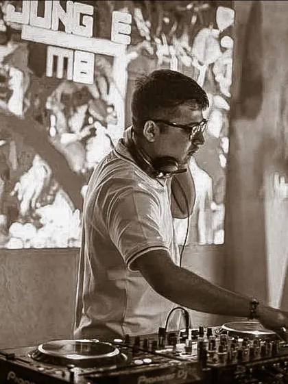 A sepia-toned, focused shot. This captures the timeless dedication to the craft of DJing.