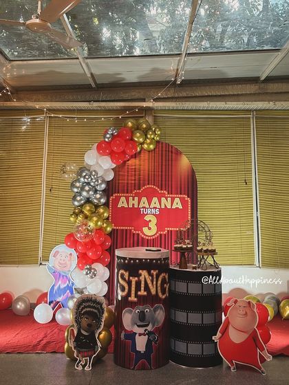 Here is the complete setup for a 'Sing' movie-themed birthday party. We created a stage-like feel with a red curtain backdrop, character cutouts, and themed plinths for desserts.
