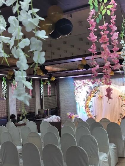 We also provide hall decoration beyond the main stage, including hanging floral elements and chair covers, to create a cohesive look for the entire event.