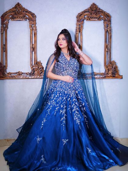 A full-length shot showing the gown's beautiful silhouette and cape.