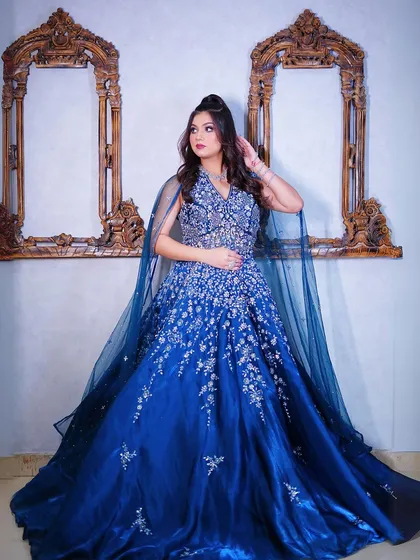 A full-length shot showing the gown's beautiful silhouette and cape.