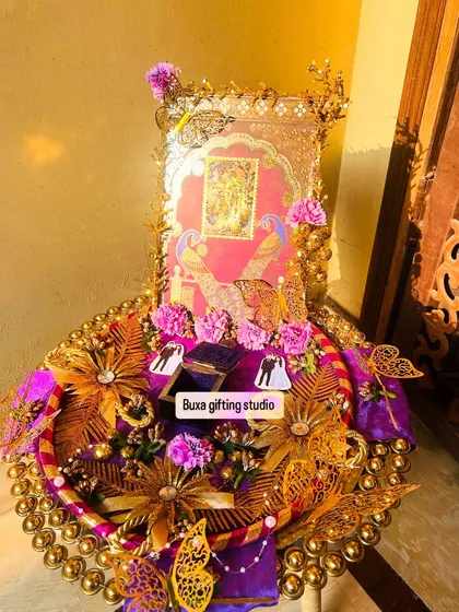 This custom engagement platter is one of my proudest creations. My client envisioned a story of divine love with Radha Krishna, peacocks, and butterflies, and I brought it to life with a 24-carat gold-plated idol, rich purple satin, and intricate gold details. It’s more than a gift; it’s a keepsake for a new beginning.