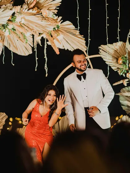 A moment of pure fun and celebration as the couple dances after their engagement. The bride proudly shows off her new ring, her expression full of excitement and joy.