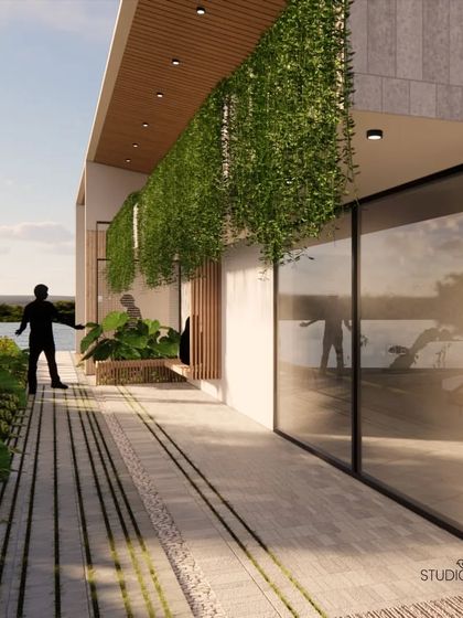 This view from the deck of the Pai Residence shows the seamless connection to the river. The design uses clean lines, natural materials, and hanging greenery to create a modern yet organic space for enjoying the waterfront location.