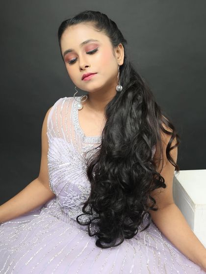 This close-up shows the detailed silver beadwork on the gown's bodice and the simple pearl drop earrings I pair with it.