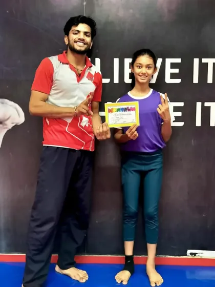 This older gymnast shows off her new certificate, proving that our recognition program motivates students of all ages to continue progressing in the sport.