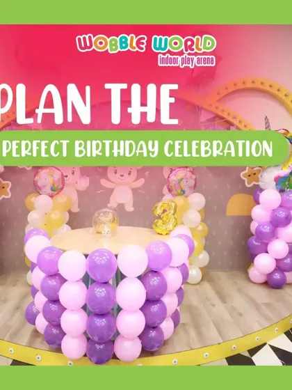 A unicorn-themed cake table setup, surrounded by purple and pink balloon columns. This shows how we can create a dedicated, beautifully decorated space for the main event.