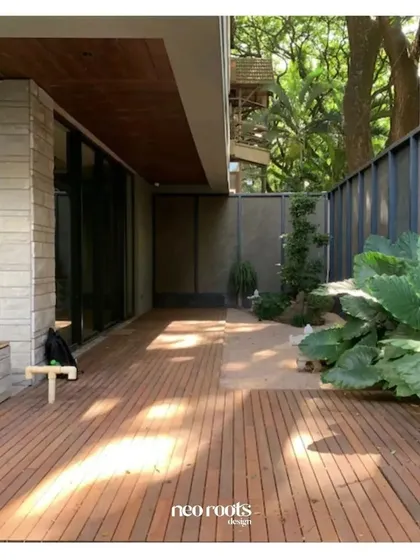 This project showcases a clean, expansive wooden deck that seamlessly extends the home's living area into the outdoors. The warm tones of the sustainable wood complement the modern architecture and surrounding greenery, creating a minimalist yet inviting space.