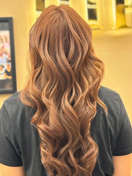Another angle of a client's beautiful new hair color. The long, flowing waves and rich tones create a look that is both glamorous and sophisticated.