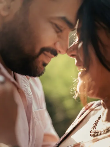 A close-up filled with warmth and sunlight. The soft focus and natural light create a dreamy, intimate portrait that feels honest and full of heart.
